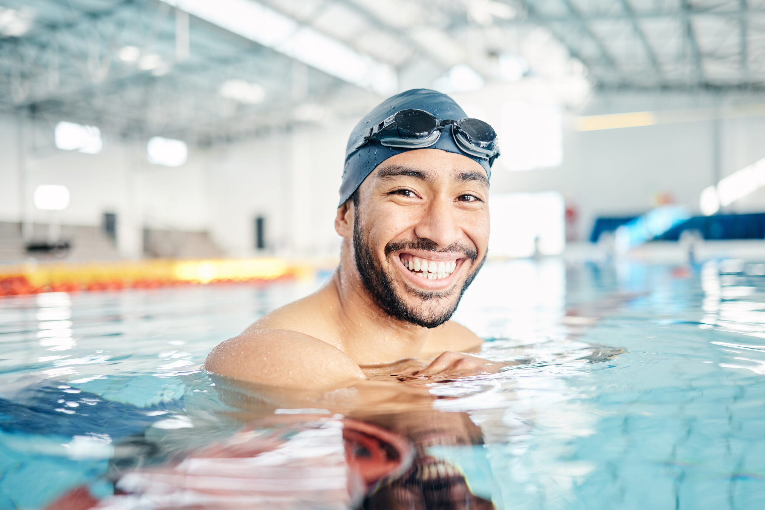 Portrait, man and relax in swimming pool with cap.